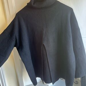 Looks like a shorter Ruti sweater. Open split front Black Turtleneck Sweater